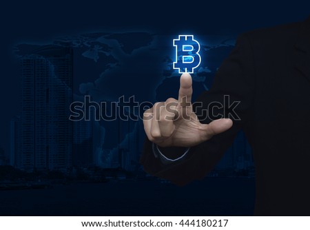 Businessman pressing bitcoin icon over map and city background, Choosing bitcoin concept, Elements of this image furnished by NASA
