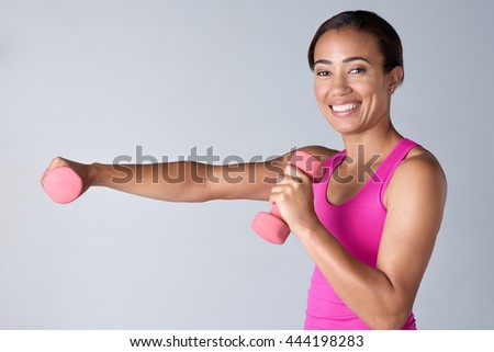 Attractive middle age woman working out with dumbbells happy and healthy lifestyle