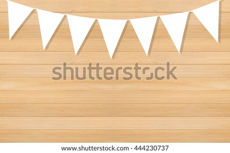 Line of white triangle flags hanging on wooden background