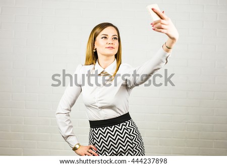 Elegant business woman making selfie with cellphone.