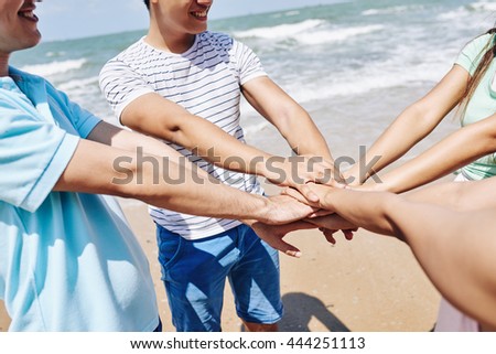 Somebody taking photo of friends jumping at the beach