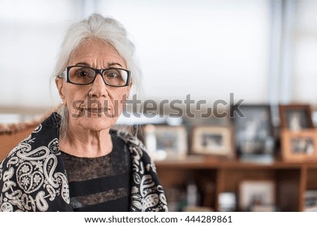 Portrait of senior woman wearing eyeglasses at home