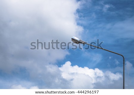 lamp post with cloud and clear blue sky