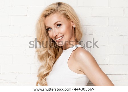 Young attractive blonde woman with long healthy hair. Beauty portrait.