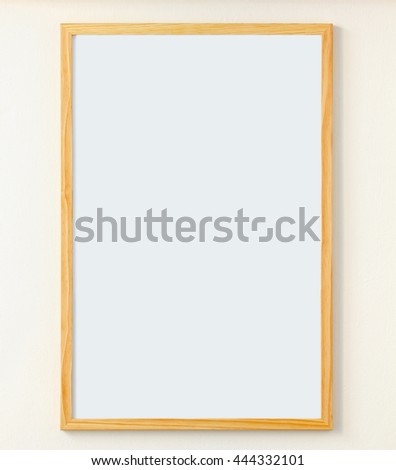Clean  white board in a wooden frame hanging on the wall, ready for use.