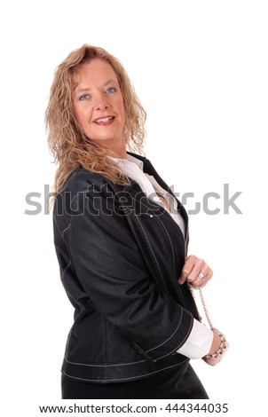 A middle age business woman in a black skirt and navy jacket standing
in profile, isolated for white background.
