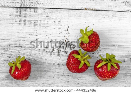 Fresh strawberries lying on the painted white table