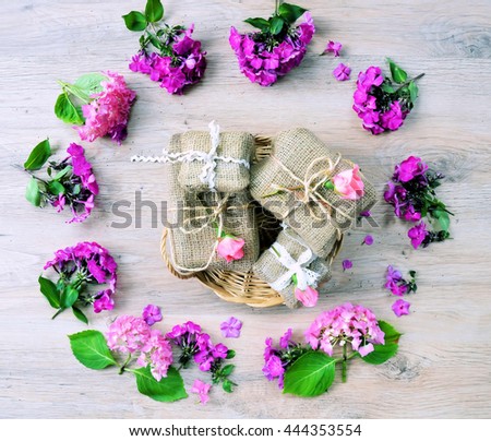 top view of a round frame of flowers and gifts  ,on a wooden vintage background 