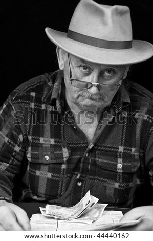 photo senior male with money issues on black background