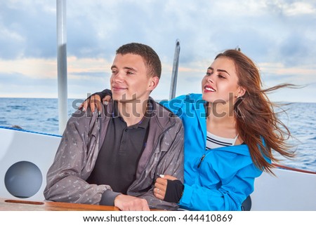 Happy couple woman and man traveling on vacation travel sailing on open sea 