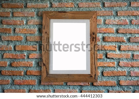 Wooden frame empty hanging on a brick wall.
