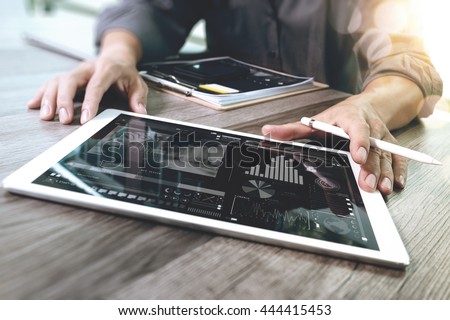 Businessman hand touching digital tablet.Photo finance manager working new Investment project.Using new technology device.Graphic icons.Strategy business stock exchanges layer effect, Horizontal
 
