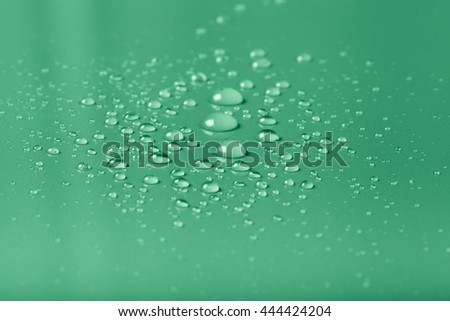 Drops of water on a color background. Green. Shallow depth of field. Selective focus. Toned.