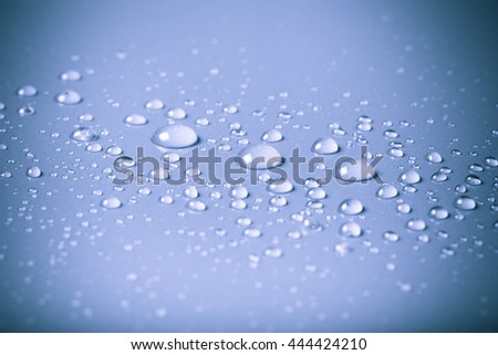 Drops of water on a color background. Blue. Shallow depth of field. Selective focus. Toned.
