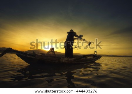 Fisherman catch fish when the sunrise.