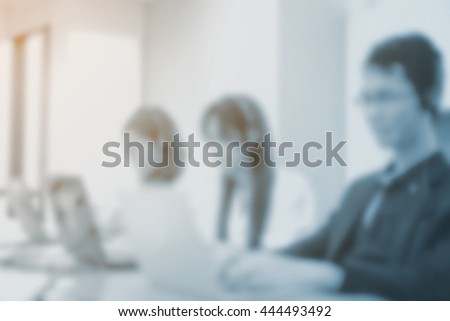 abstract blurred group of asian employee work as call center in office room. Royalty-Free Stock Photo #444493492