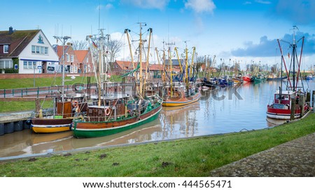 Old Historic Harbor With Fishing Boats in Greetsiel, Lower Saxony, Germany. February 2016. Royalty-Free Stock Photo #444565471