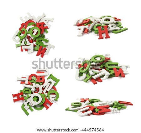 Pile of colorful white, red, green colored wooden letters isolated over the white background
