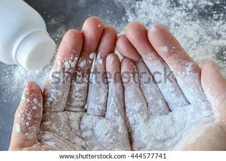Talcum powder on two hands Royalty-Free Stock Photo #444577741