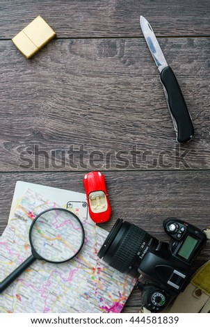 Outfit of traveler or student. Overhead of essentials for modern young person. Different objects on wooden background.