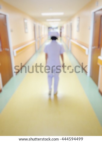 Background blur a nurse coming in the front of the room patients to take care  in the hospital.
