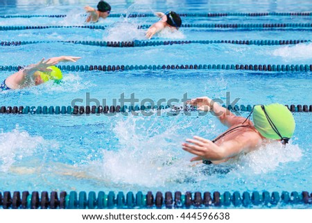 Women's Butterfly race, focus on center lane line, some motion blur Royalty-Free Stock Photo #444596638