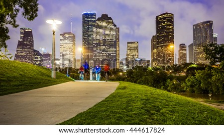 Houston city skyline as night falls and people enjoying Eleanor Tinsley Park