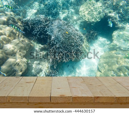 wood table top on background of coral reef underwater view for snorking drive sport - can use to display or montage on product