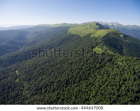Photos from the bird's-eye view. The mountain ridge covered with forest. Mountain landscape. Caucasus.