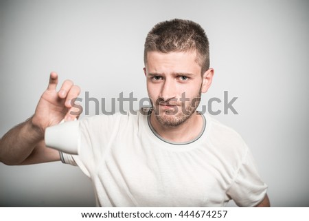 successful man with an empty cup of coffee isolated on gray background