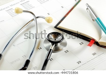 A desktop with stethoscope, notebook, pen and calendar