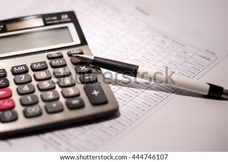 calculator and pen on a business background Royalty-Free Stock Photo #444746107