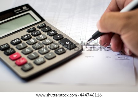 work on the calculator and papers close up Royalty-Free Stock Photo #444746116