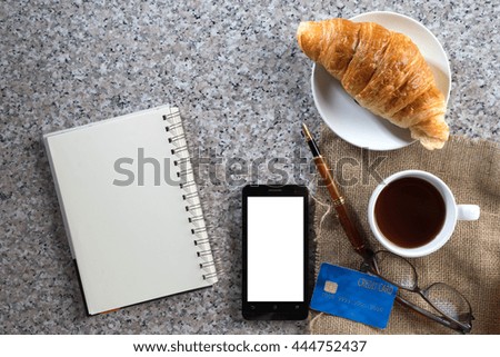 business work on marble table coffee with croissant bakery  top view white space in smartphone