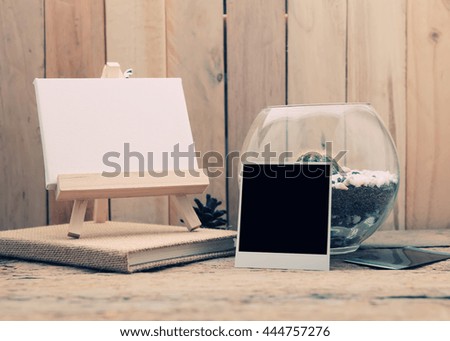 Photo frame with copy space on wood table background - vintage effect style. 