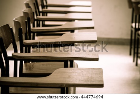 Chair in empty classroom, lecture armchairs in school