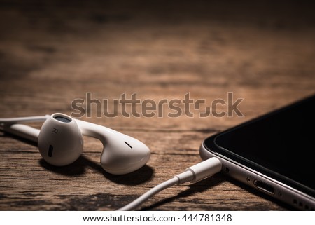 Headphone and phone media portable on dark tone. 