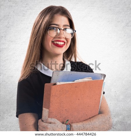 Girl holding several college notes over textured background