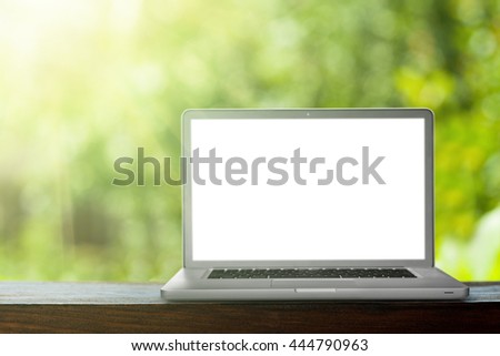 laptop on the green bokeh backrounds. Like ipade