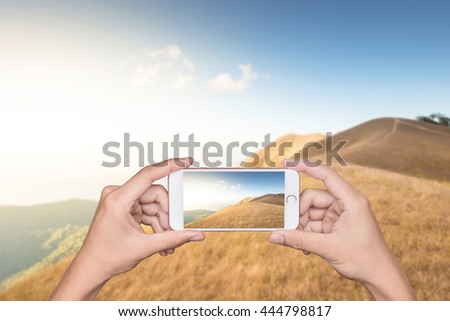 man hand take a photo with samrt phone on moutain view