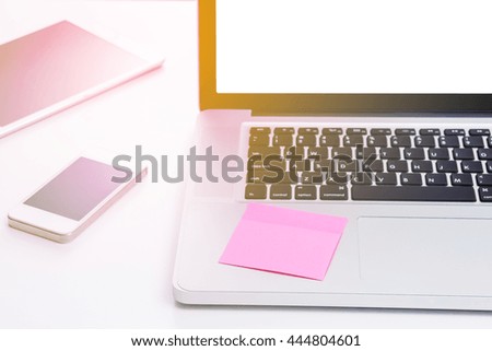Adhesive paper note on laptop computer with light effected