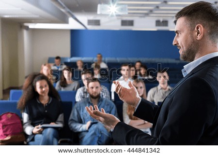 Profile picture of a successful academic teacher giving a lively lecture to a group of students