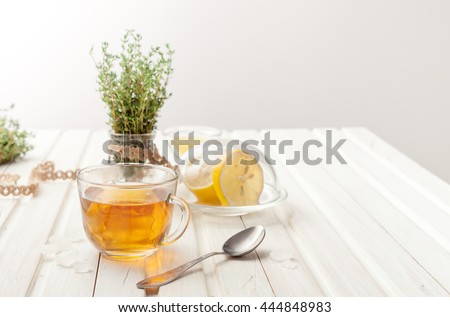 herbal teas with lemon and thyme on the garden table Royalty-Free Stock Photo #444848983