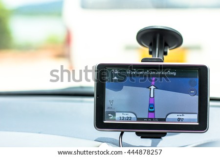 GPS navigator is a device indicating available roads and alternative routes to the destinations. The vehicle this device mounted with, is in line with others to get onto a ferry to cross to an island.