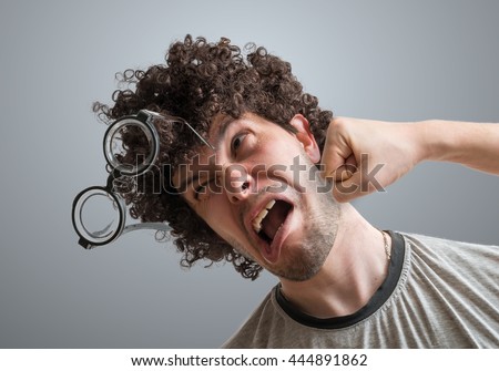 Funny man is getting punch in face with fist. Royalty-Free Stock Photo #444891862
