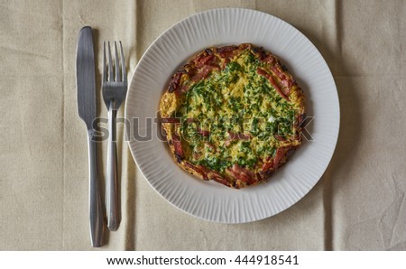 Omelette with bacon and sausage, top view.