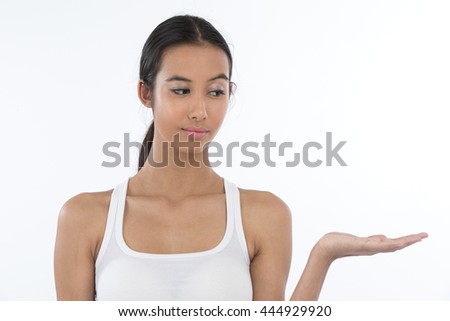 Portrait of a teenage girl presenting imaginary object in her hand