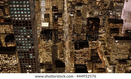 aerial view of modern illuminated city skyscraper buildings at night lights. new york urban metropolis scenery. high rise real estate apartment background