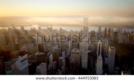 aerial view of modern city skyline background at sunset light. new york urban metropolis scenery. high rise real estate apartment buildings