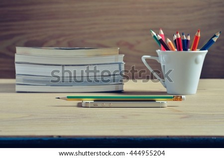 Selective focus Smart phone and pencil on desk wood background 